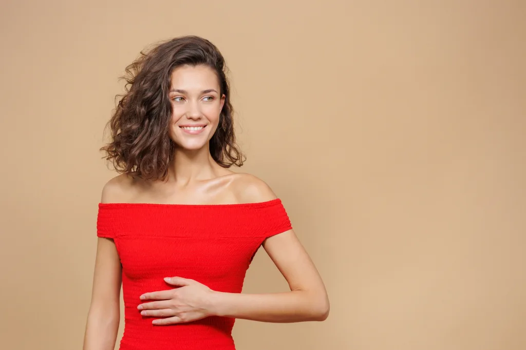 the woman holds her hand on her stomach. pain in the stomach or intestines